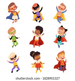 Set with cute kids superheroes. Joyful guys in superhero costumes jump and laugh