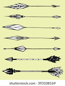 Set of decorative arrows. Stylized arrows. Black and white drawing by hand. Line art. The arrows with feathers. Weapons.