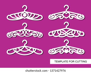 Set of decorative clothes hangers for atelier, wedding salon, boutique or store. White objects on pink background. Template for laser cutting, wood carving, paper cut and printing. Vector illustration