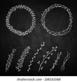 set of decorative doodle wreaths made of branches. two wreaths from plants and six different branches. background chalkboard