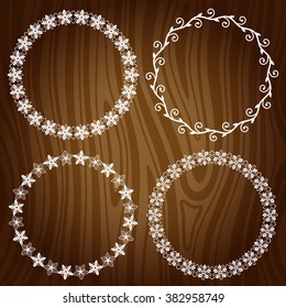 Set of decorative floral frames on wooden background