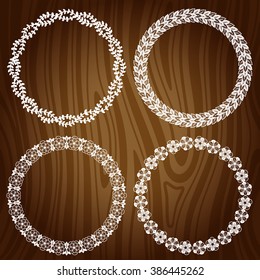 Set of decorative floral frames on wooden background