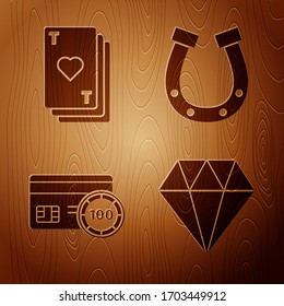 Set Diamond, Playing card with heart, Credit card and Horseshoe on wooden background. Vector