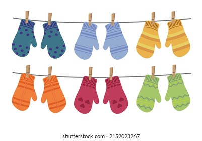 Set of different colorful mittens hanging on the rope. Wool mittens dry and hang on laundry string with clothespins. Vector illustration