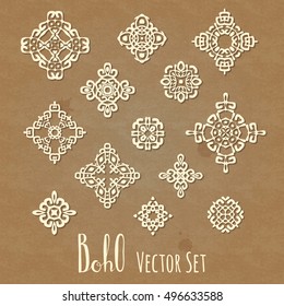 Set of different ethnic signs and design elements with shadows and Boho hand drawn lettering. On cardboard texture craft paper background. Vector illustration.