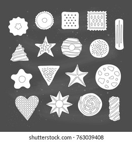 Set of different hand drawn cookies with chocolate and jelly isolated on chalkboard background. Top view.