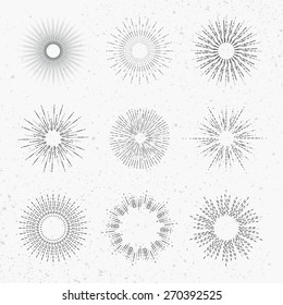 Set of different sunbursts on light background. Vector illustration