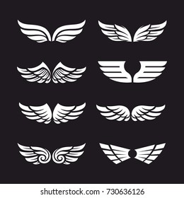 Set of different vector wings isolated on dark background. Vector wing shapes. Wing icons.