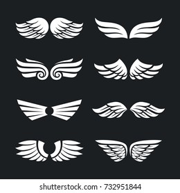 Set of different vector wings isolated on dark background. Vector wing shapes. Wing icons.