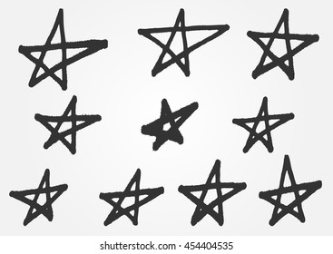 A set of distorted stars from the hand of a rough brush. Grunge sketch. 10 isolated abstract elements.