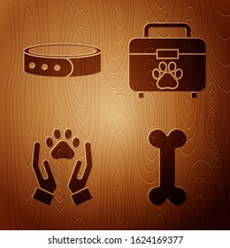 Set Dog bone, Collar with name tag, Hands with animals footprint and Pet first aid kit on wooden background. Vector