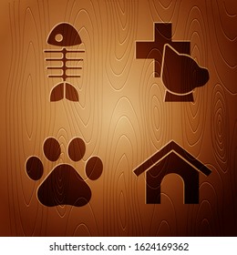Set Dog house, Fish skeleton, Paw print and Veterinary clinic symbol on wooden background. Vector