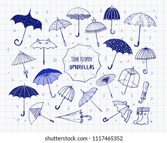 Set of doodle blue pen sketch umbrellas on lined paper background.