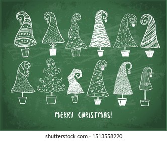 Set of doodle christmas trees on blackboard background