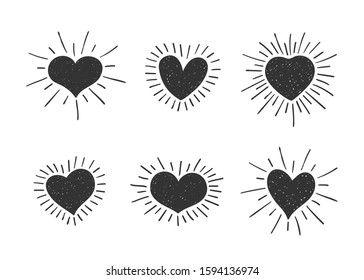 Set of doodle heart shaped symbols with retro styled sun rays. Collection of different hand drawn romantic hearts for sticker, label, love logo and Valentines day design.