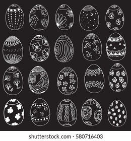 Set of Easter eggs. Hand-drawn decorative elements in vector. white pattern on the black, board chalk background 