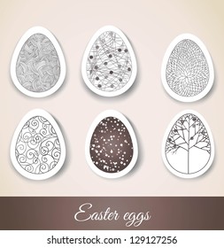 Set of Easter eggs with patterns on cut paper. Vector illustration