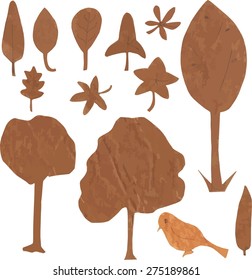 A set of ecologically themed isolated design elements cut out of brown kraft paper: trees, leaves and a bird, scalable vector graphic