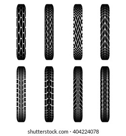 Set of eight black bike tire tracks with shadows