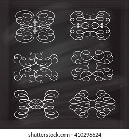 Set of elegant white flourishes for your design on the chalkboard.