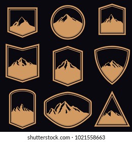 Set of empty badges with mountains in golden style. Design elements for logo, label, emblem, sign. Vector illustration