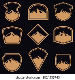 Set of empty badges with mountains in golden style. Design elements for logo, label, emblem, sign. Vector illustration