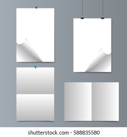 Set of empty isolated realistic vertical paper posters with curled corners,  paper clips, traces of the folded sheet and red, blue push pins on grey wall. Vector illustration. Mock up.
