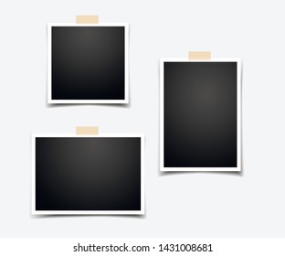 Set of empty photo frames with adhesive tape and a white sticker under it for notes and reminders.