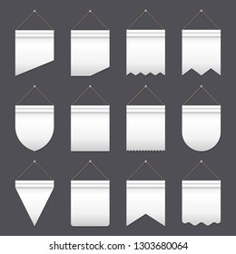 Set of empty white pennants of various shapes hanging on gray background