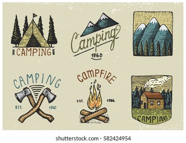 set of engraved vintage, hand drawn, old, labels or badges for camping, hiking, hunting with tent, axe and campfire with mountains.