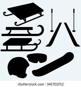 Set equipment for snowboarding, pair skis and wooden sled. Isolated on blue background. Vector silhouettes