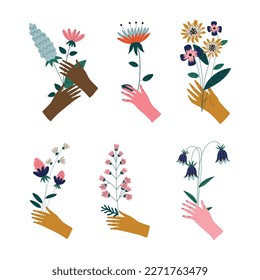 Set of female hands holding bunches of blooming flowers. Elegant bouquets of delicate meadow flowers cartoon vector illustration