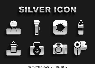 Set First aid kit, Bottle of water, Paper towel roll, Photo camera, Trash can, Sun, Barbecue grill and Flashlight icon. Vector