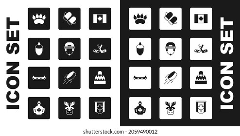 Set Flag of Canada, Hockey helmet, Acorn, Bear paw footprint, Ice hockey sticks, Christmas mitten, Beanie hat and Kayak icon. Vector