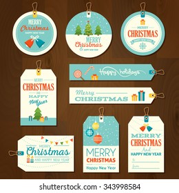 Set of flat design Merry Christmas and Happy New Year cute ready-to-use gift tags, Sale labels, price tags isolated on wood background. Christmas badges, banners, templates, design elements.