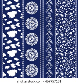 Set of floral batik borders. Wildflowers seamless pattern, paisleys, leaves stripes, gypsy and ethnic motifs. Ethnic textile collection. White on dark blue. 