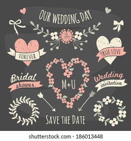 A set of floral design elements, wreaths, ribbons, arrows and hearts in chalkboard style.