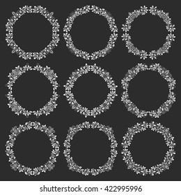 Set of floral round frames in victorian vintage style. Circular wreaths bundle in victorian style. White elements for design on black background.