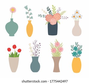 Set of flowers in vases on white