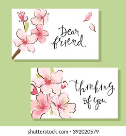 Set of flyers or greeting cards with cherry blossom design and hand-written inscription. Gentle,  trendy design. Vector illustration.