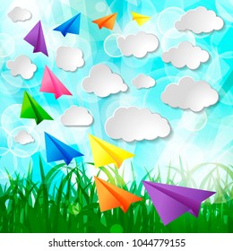 Set of flying color paper planes with white paper clouds on green spring nature lawn landscape background