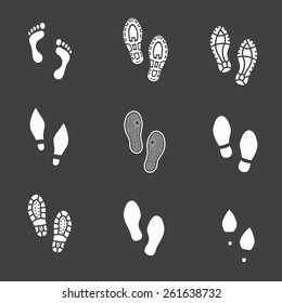 Set of footprints and shoeprints icons showing bare feet  in white showing bare feet and the imprint of the soles with the differing patterns of male and female footwear with shoes  boots and high