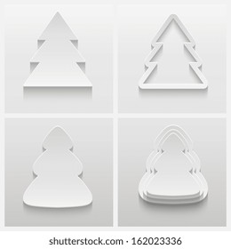 Set of four 3d christmas trees made from paper on gray background.  Abstract design