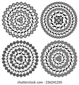 Set of four 4 ethnic monochromatic design elements isolated on white. Winter nordic round pattern borders in collection. Vector illustration. Could be used for web-design, decoration, etc. 
