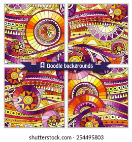 Set of four abstract doodle ethnic tribal hand drawn vector cards on wood background. Paisley batik background. Series of template frame design for card. Pattern with geometric mosaic elements.