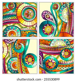 Set of four abstract doodle ethnic tribal hand drawn vector cards on wood background. Paisley batik background. Series of template frame design for card. Pattern with geometric mosaic elements.
