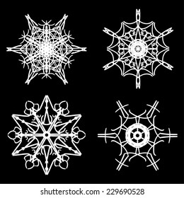 Set of four beautiful drawn snowflake silhouettes