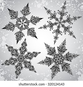 SEt of four beautiful hand drawn ornamental doodle snowflakes.