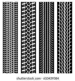 Set of four black tire track silhouettes isolated on white background