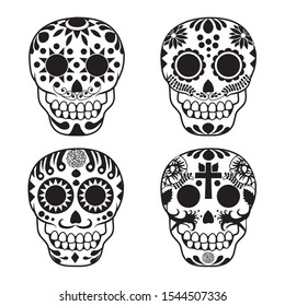 Set of four black and white Mexican sugar skulls